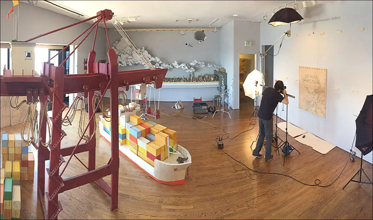 Art studio with model ship and photography equipment.