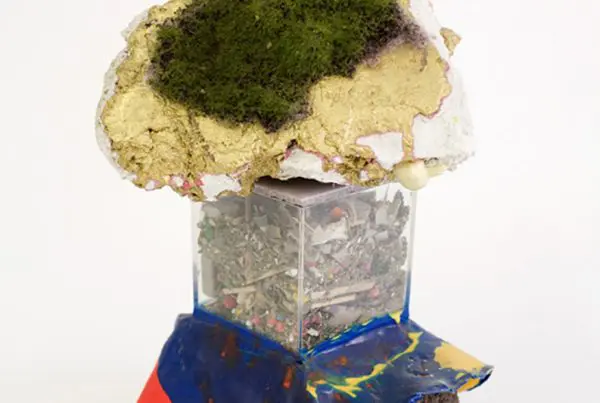 A mixed-media sculpture of a palm tree-topped island.