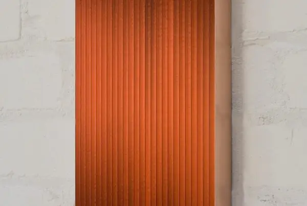 Orange corrugated metal wall sculpture.
