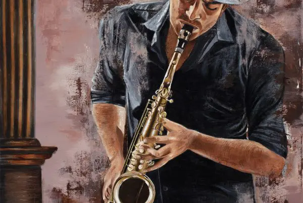 Man playing saxophone with gray hat.