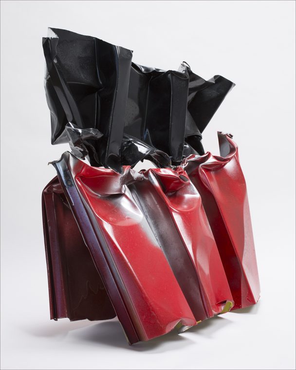 Black and red crumpled metal sculpture.