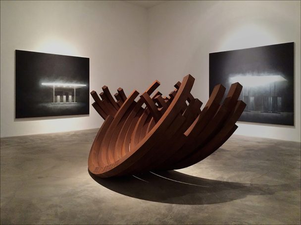 A large rusty metal sculpture in the shape of a boat.