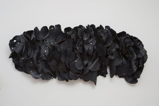 Black rubber petals wall sculpture.