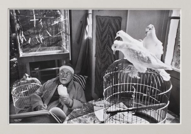 Black and white photo of Picasso with doves.