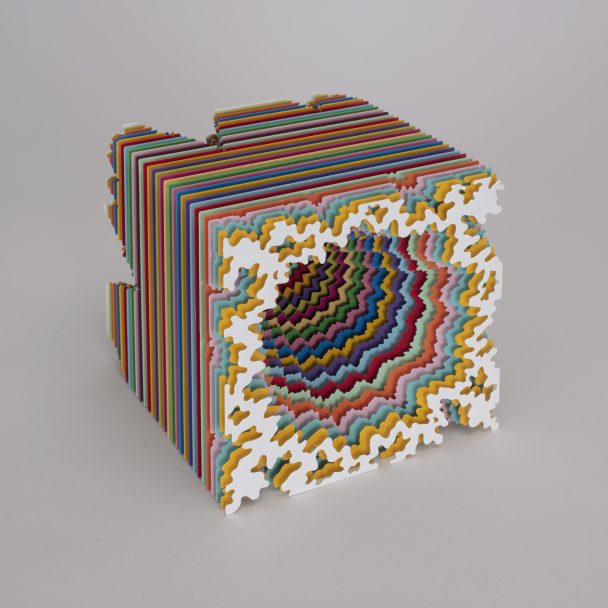 A hollow cube made of many layers of colored paper.