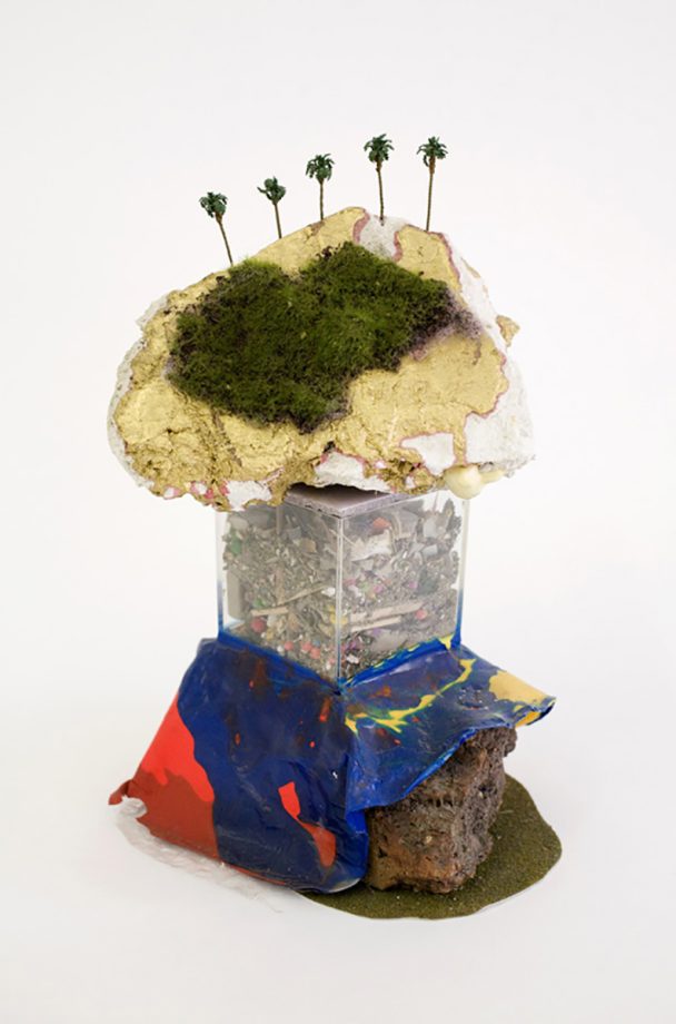 A mixed-media sculpture of a palm tree-topped island.