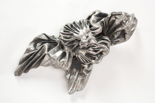 A crumpled metal sculpture resembling a flower.