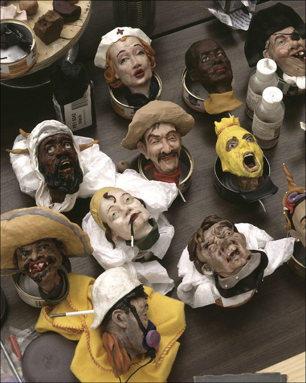 A collection of clay sculptures of people's heads.