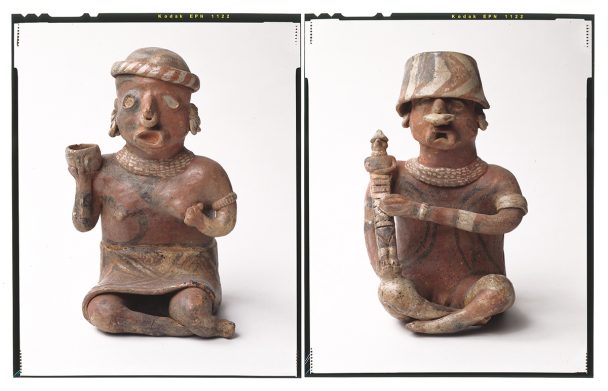 Two ancient clay figures with elaborate headwear.